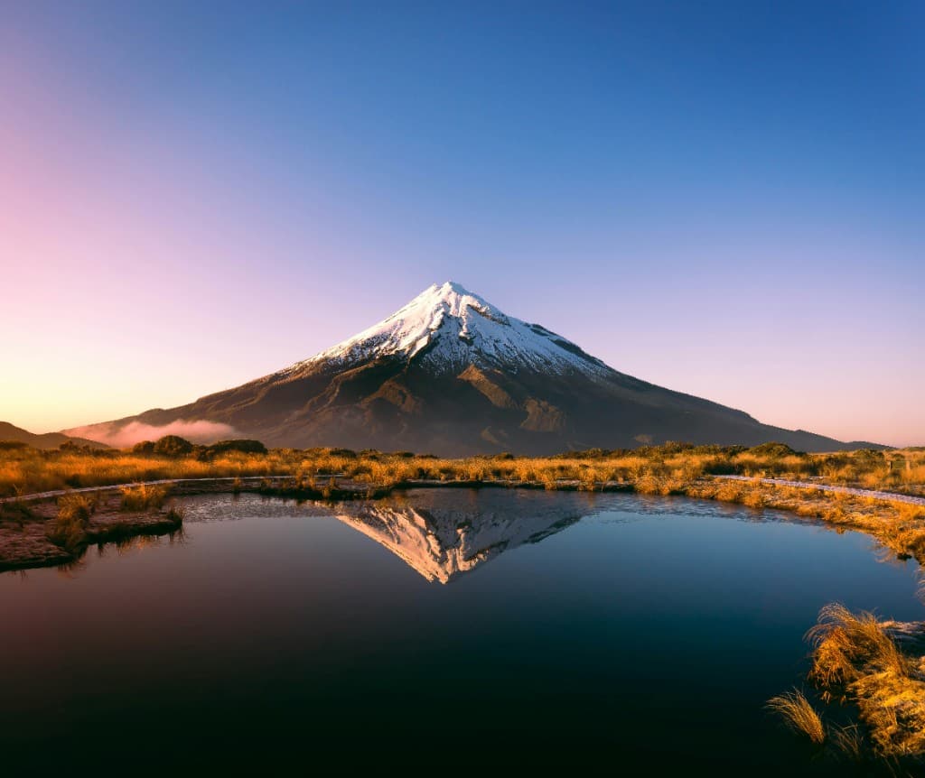 Mount Taranaki reflected in an alpine pool at dawn